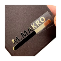 Black metal nameplate with engraved M Makro logo