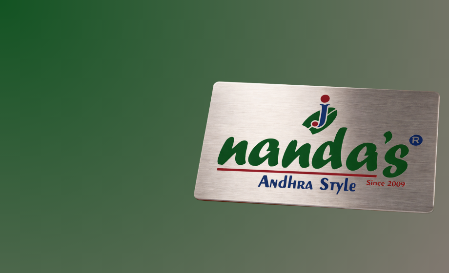 Brushed metal nameplate with Nanda’s Andhra Style logo and colorful text
