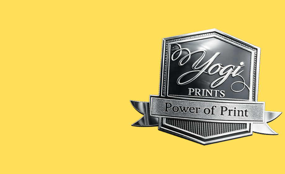 Silver metal embossed logo badge with Yogi Prints text and ribbon design